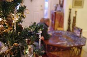 Thane and Adam puzzle by the light of the tree