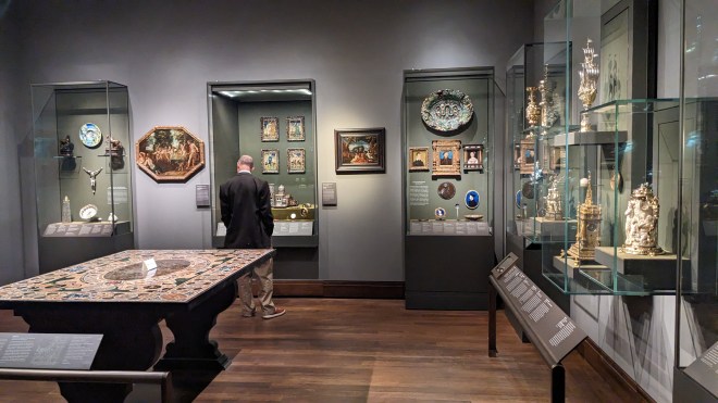 A man looking at an art exhibit in a museum