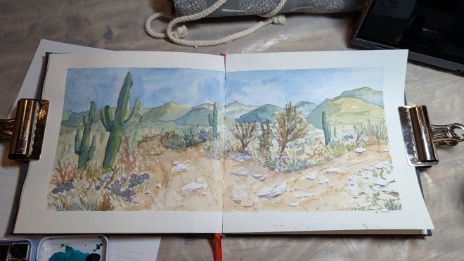 A two page spread of a desert panorama done in watercolor