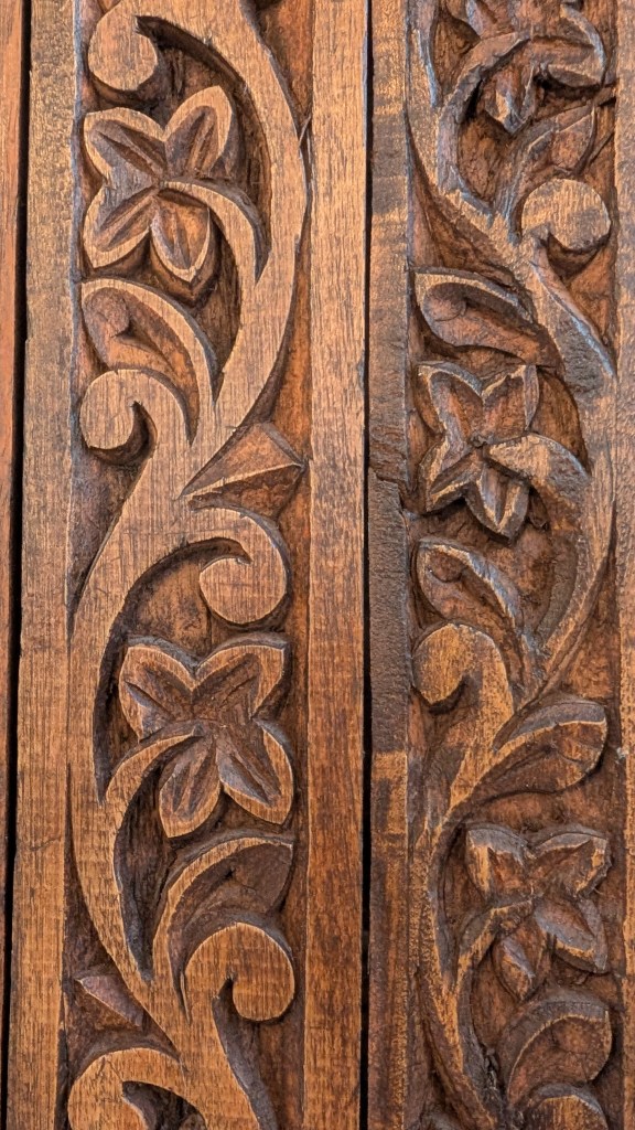 A close up of richly carved wood in a floral scene